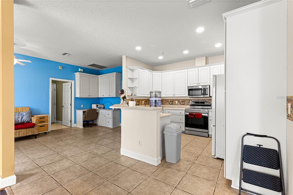 6551 Southeast 11th Loop Ocala, FL 34472 - Photo 9 of 46 a kitchen with refrigerator and cabinets