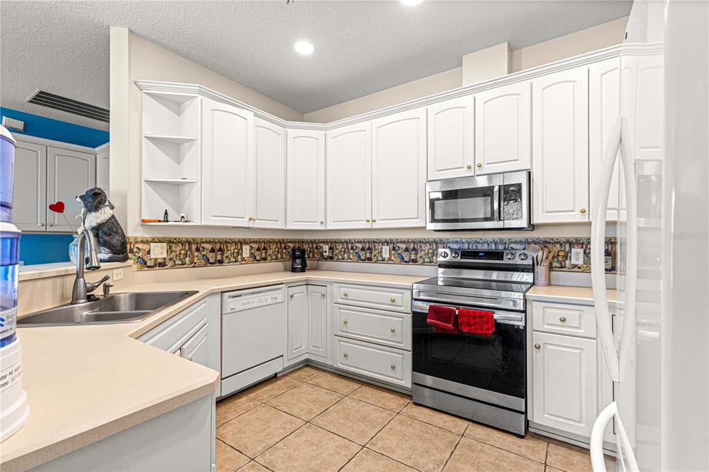 6551 Southeast 11th Loop Ocala, FL 34472 - Photo 10 of 46 a kitchen with cabinets appliances and a sink