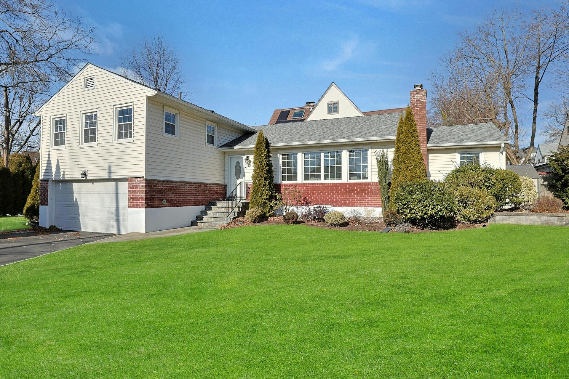 a front view of a house with a garden