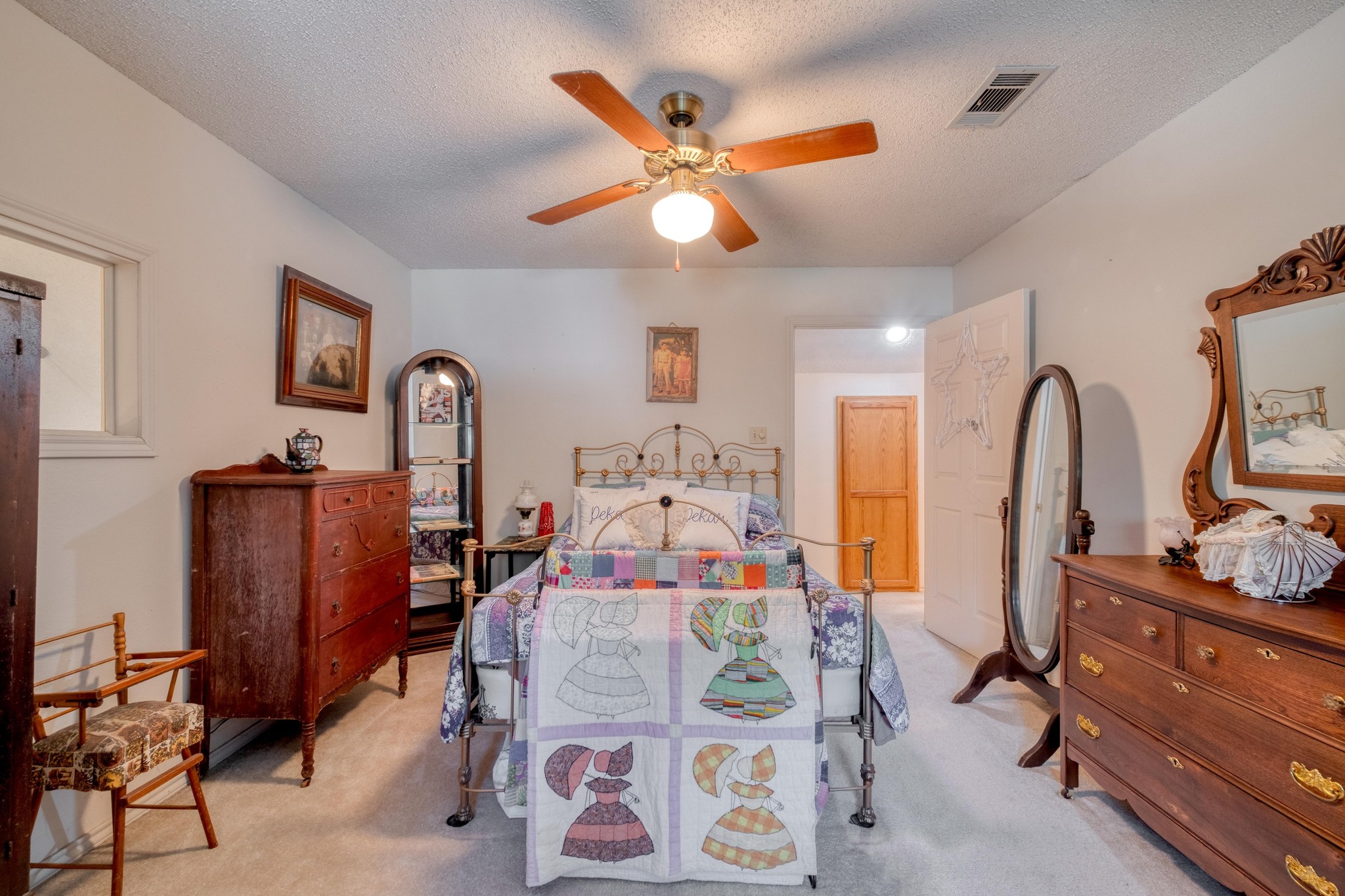 153 Pleasant Grove Road Elgin, TX 78621 - Photo 20 of 34 Bedroom with a textured ceiling, light colored carpet, and a ceiling fan