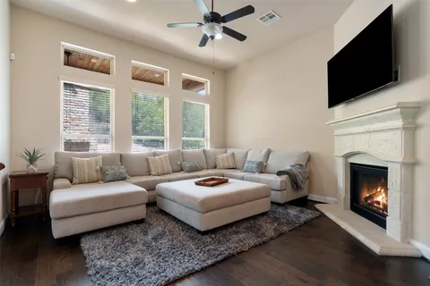 a living room with furniture a flat screen tv and a fireplace