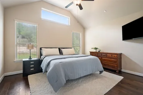 a bedroom with a bed and flat screen tv