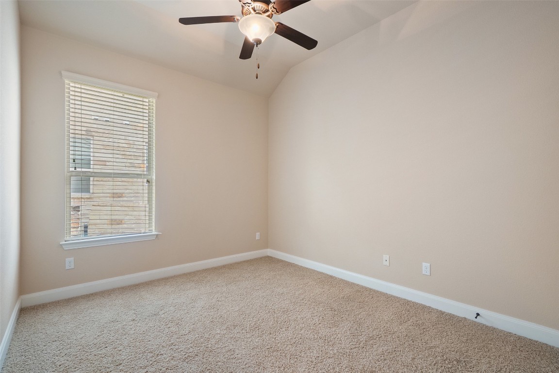 209 Maxwell Way Austin, TX 78738 - Photo 25 of 32 an empty room with a window and a fan
