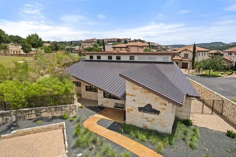 an aerial view of a house with a garden and lake view