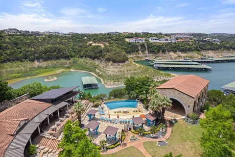 an aerial view of residential building with outdoor space and lake view