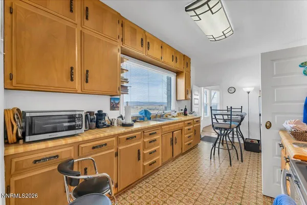 a kitchen with stainless steel appliances granite countertop a stove a sink and a cabinets