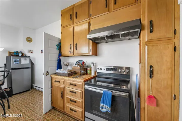 a kitchen with stainless steel appliances granite countertop a stove and a refrigerator