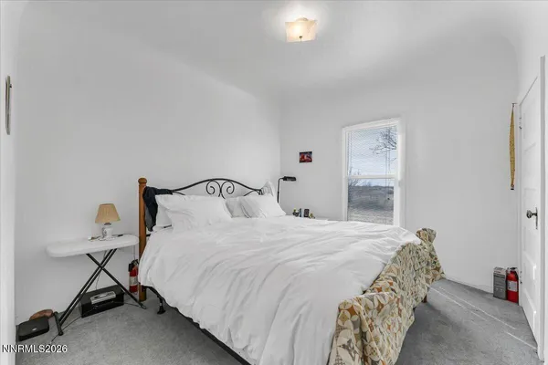 a bedroom with a bed and a table in it