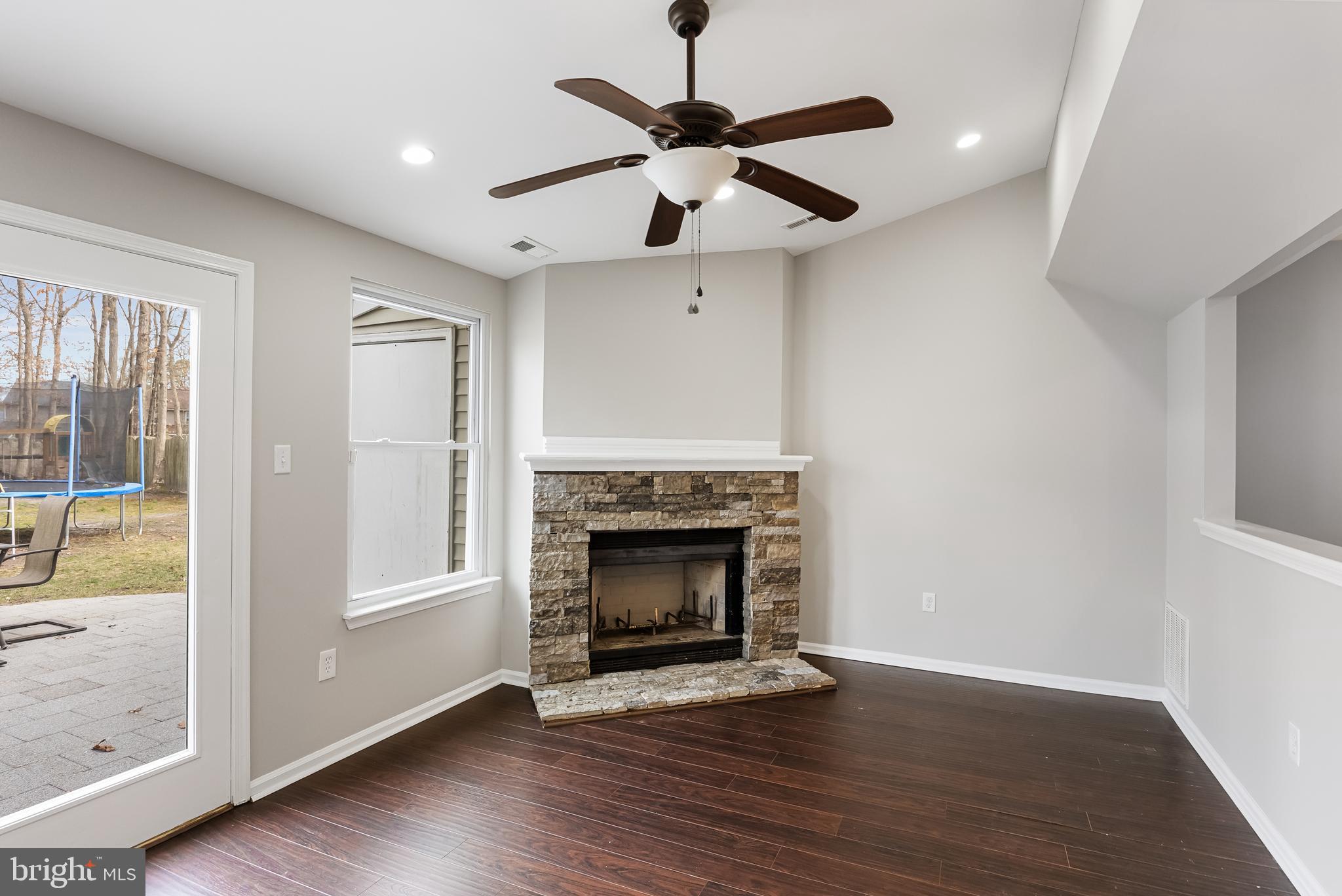 150 Baker Avenue Atco, NJ 08004 - Photo 13 of 32 a view of an empty room with wooden floor fireplace and a window