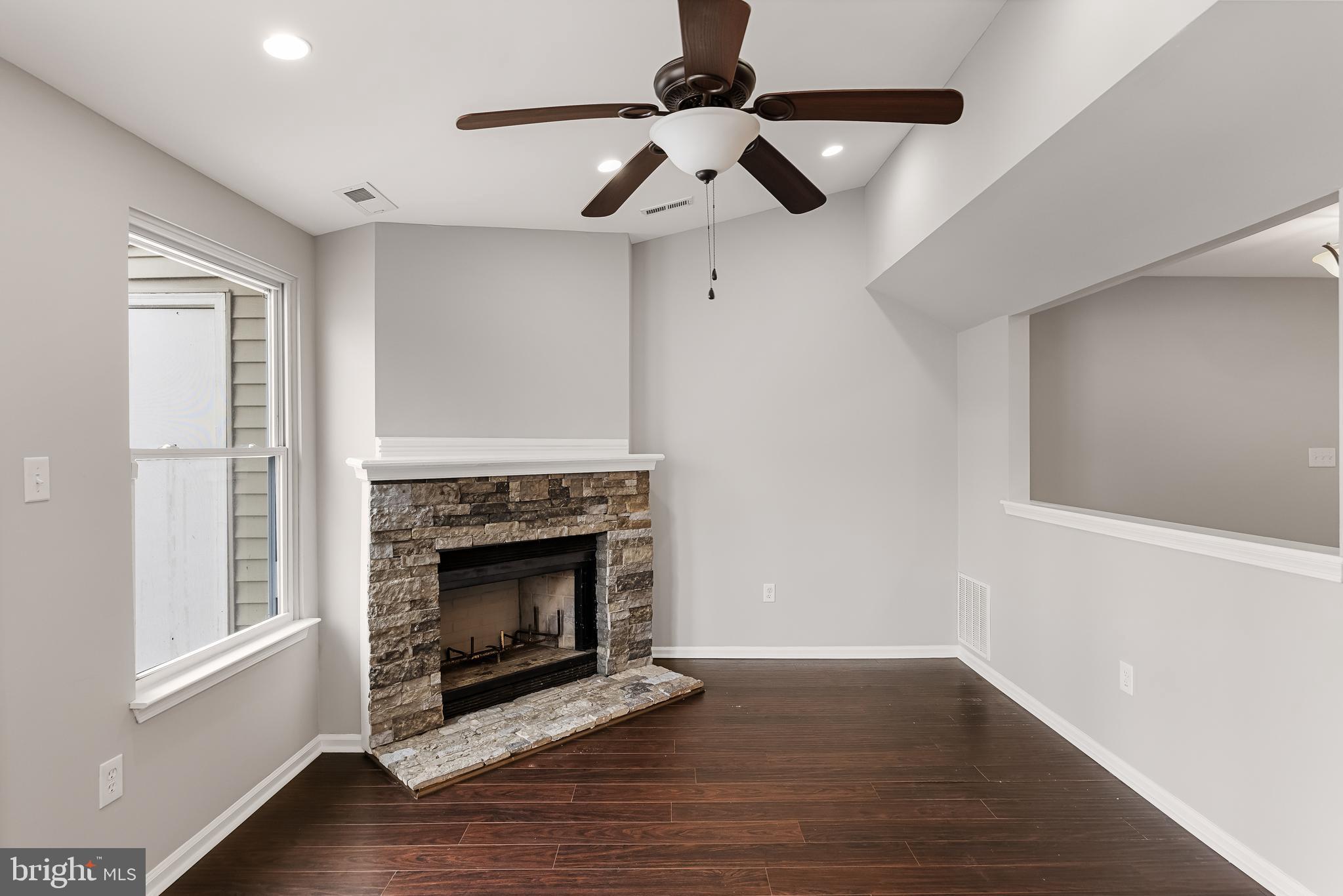 150 Baker Avenue Atco, NJ 08004 - Photo 14 of 32 a living room with wooden floor a fireplace and a window