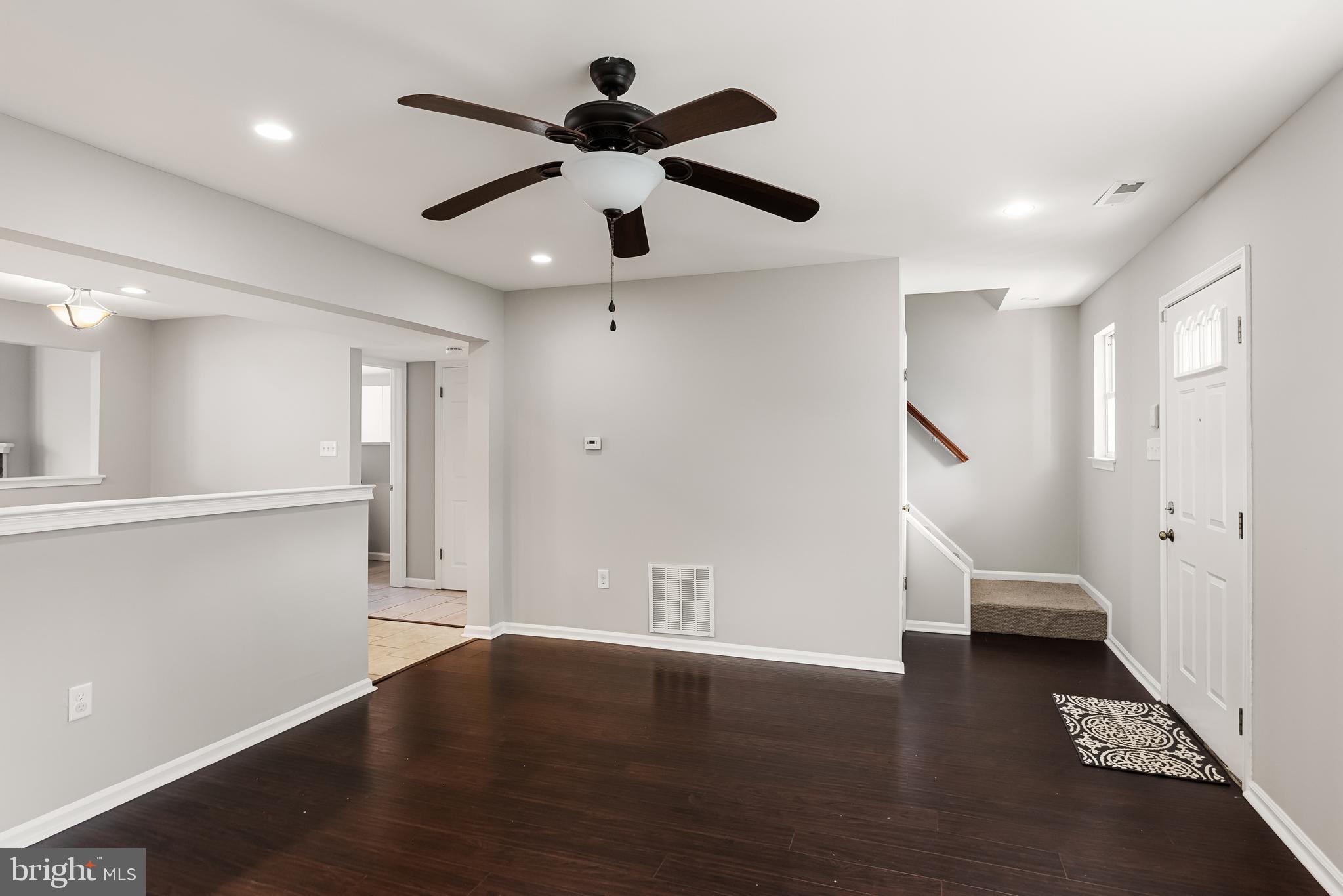 150 Baker Avenue Atco, NJ 08004 - Photo 7 of 32 a view of an empty room with wooden floor and a ceiling fan