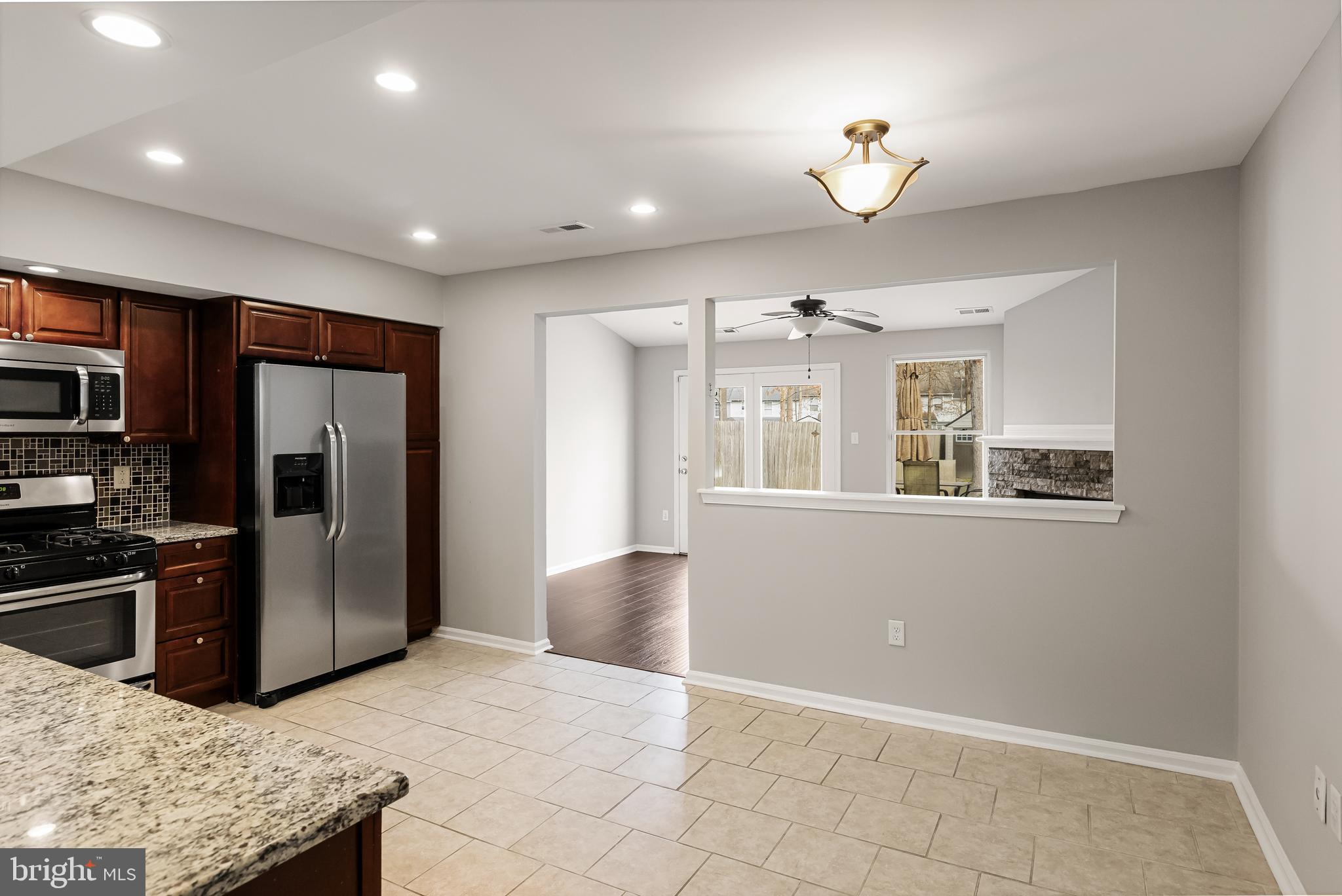 150 Baker Avenue Atco, NJ 08004 - Photo 8 of 32 a kitchen with stainless steel appliances granite countertop a refrigerator a oven a sink with a dining table and chairs