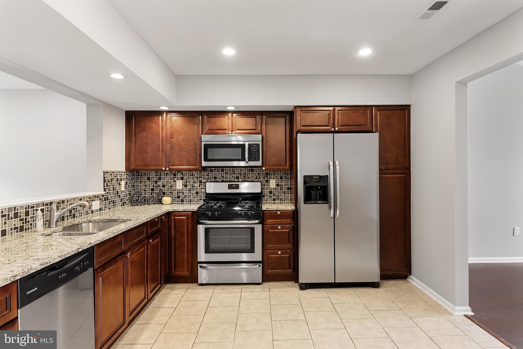 150 Baker Avenue Atco, NJ 08004 - Photo 9 of 32 a large kitchen with stainless steel appliances granite countertop a stove a sink and a refrigerator