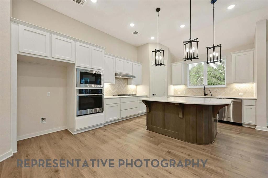 2620 Brooklyn Street Forney, TX 75126 - Photo 1 of 19 a kitchen with kitchen island a sink stainless steel appliances and cabinets