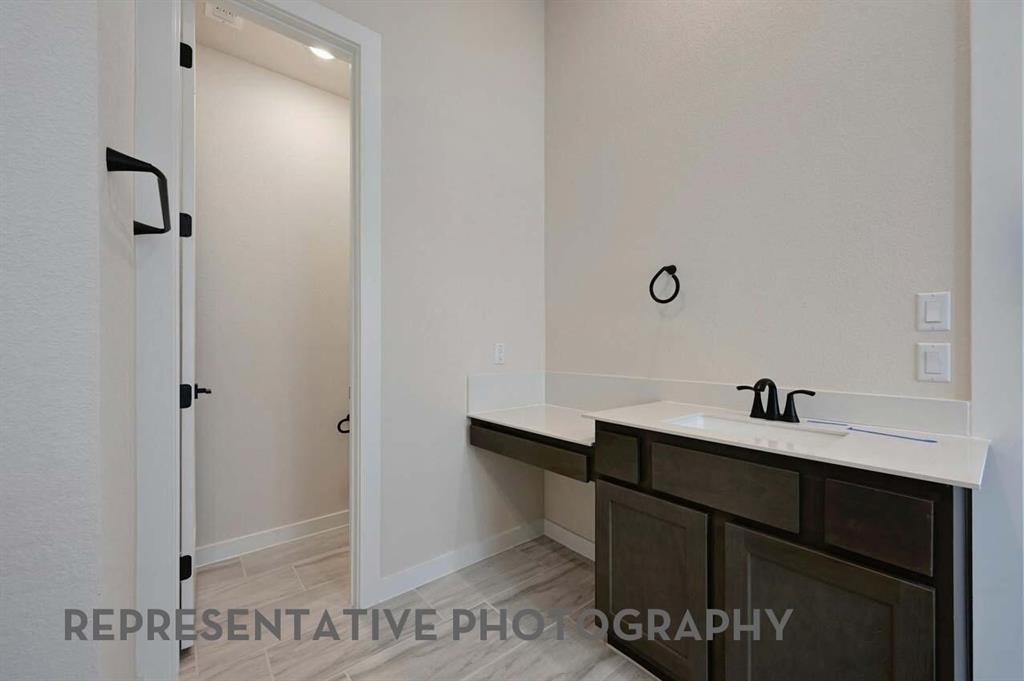 2620 Brooklyn Street Forney, TX 75126 - Photo 11 of 19 a bathroom with a sink and a mirror