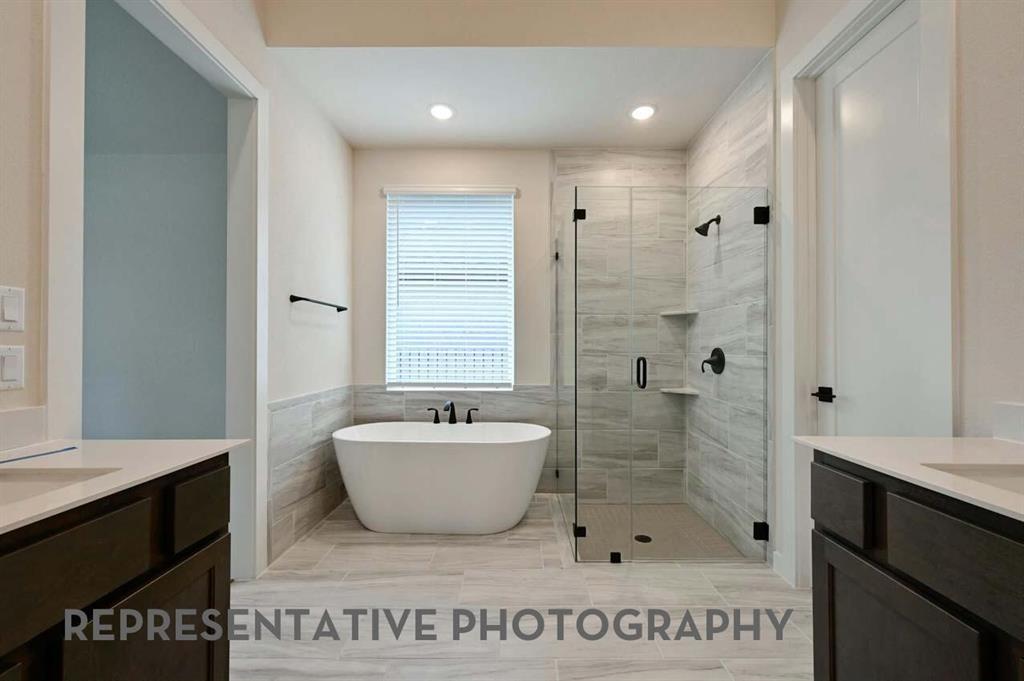 2620 Brooklyn Street Forney, TX 75126 - Photo 12 of 19 a spacious bathroom with a shower a sink and a mirror
