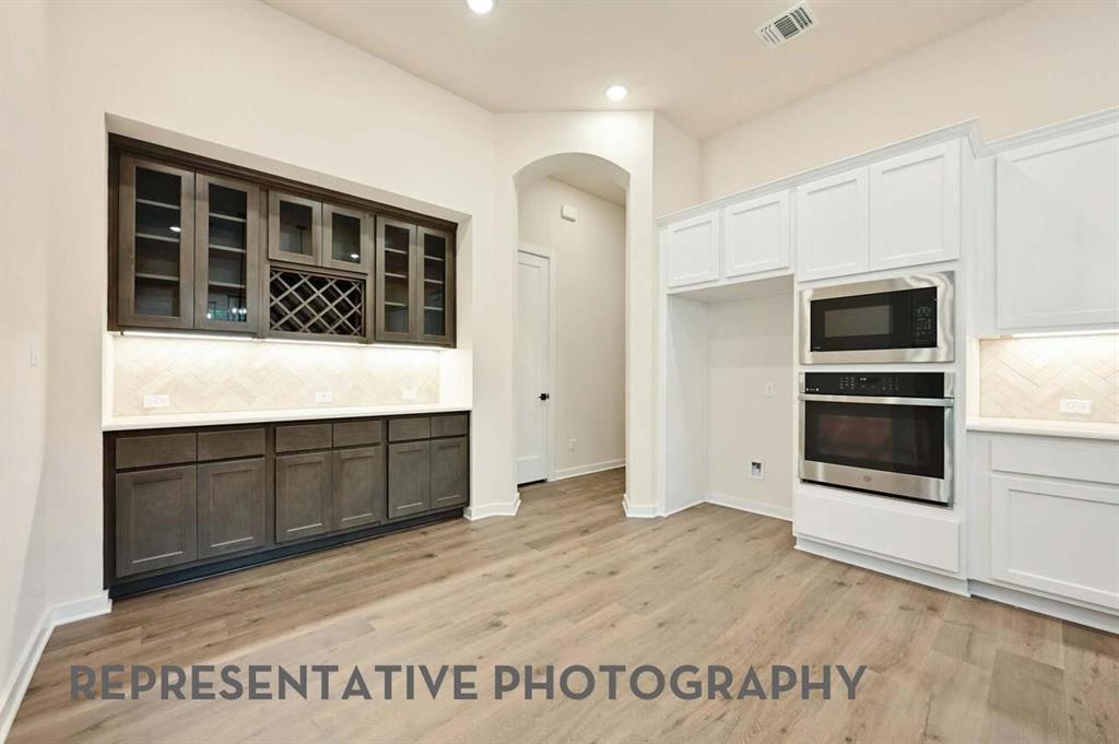 2620 Brooklyn Street Forney, TX 75126 - Photo 17 of 19 a view of kitchen with stainless steel appliances granite countertop a stove a microwave and a refrigerator