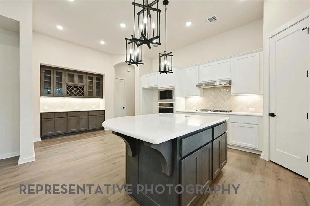 2620 Brooklyn Street Forney, TX 75126 - Photo 3 of 19 a kitchen with kitchen island a sink counter top space and stainless steel appliances
