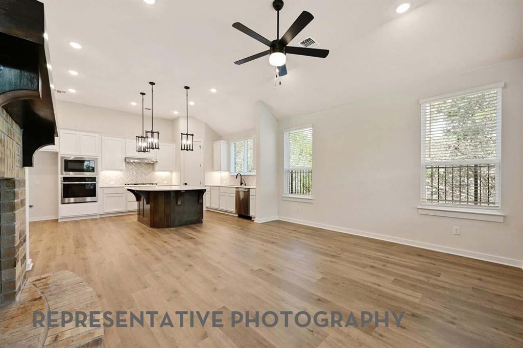 2620 Brooklyn Street Forney, TX 75126 - Photo 5 of 19 a view of an empty room with a window and wooden floor