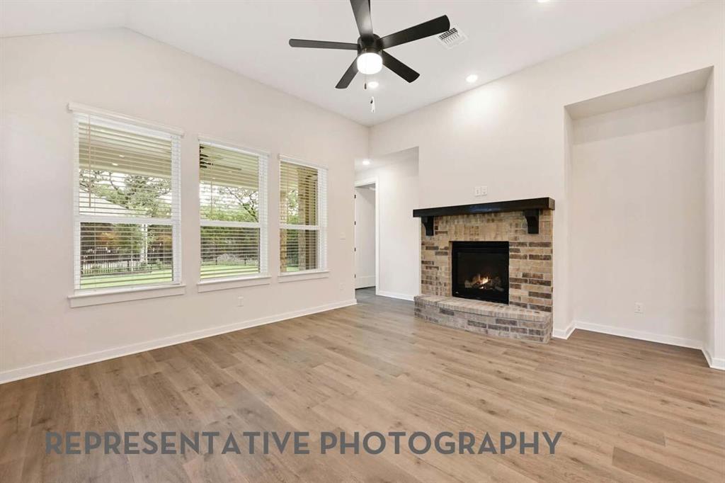 2620 Brooklyn Street Forney, TX 75126 - Photo 6 of 19 a view of an empty room with a fireplace and a window