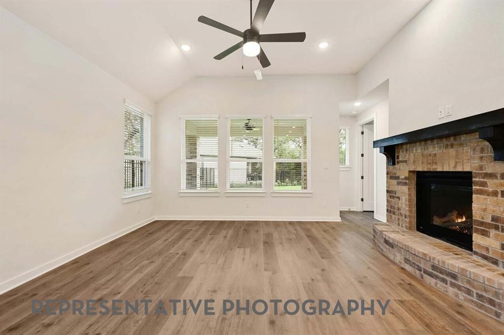 2620 Brooklyn Street Forney, TX 75126 - Photo 7 of 19 an empty room with windows and a fireplace