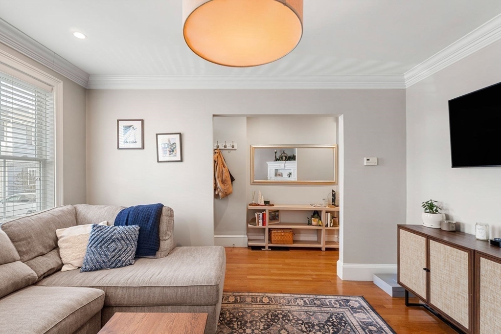 51-53 Story Street, Unit 1 Boston, MA 02127 - Photo 3 of 33 a living room with furniture and a flat screen tv