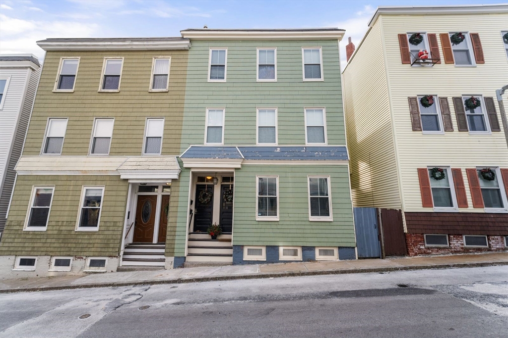 51-53 Story Street, Unit 1 Boston, MA 02127 - Photo 31 of 33 a view of a brick building with many windows