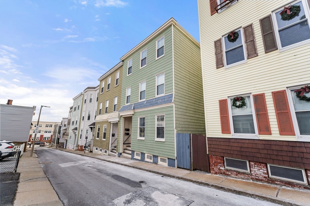 51-53 Story Street, Unit 1 Boston, MA 02127 - Photo 32 of 33 a front view of a building with many windows