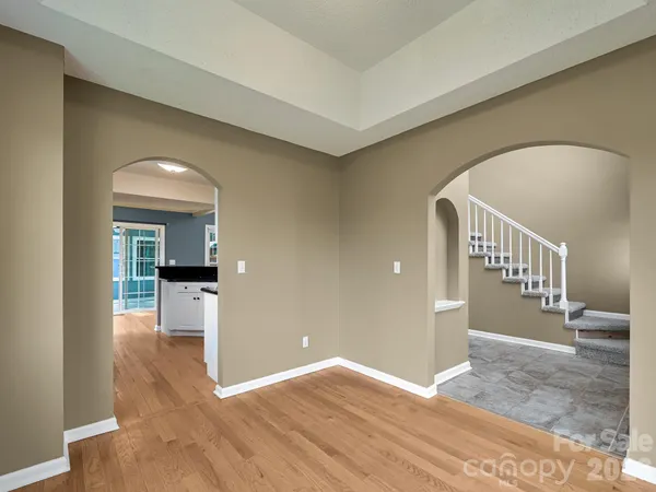 a view of a hallway view with wooden floor and staircase