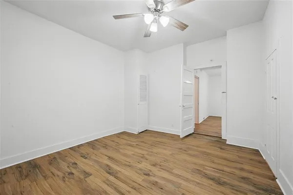 a view of empty room with wooden floor
