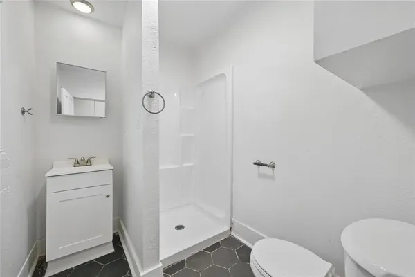 a bathroom with a toilet a sink and shower