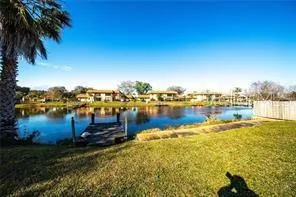 a view of a lake with houses in the back