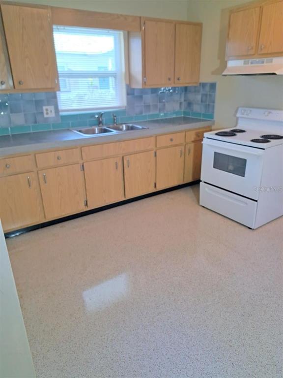 10165 106th Terrace, Unit 1 Largo, FL 33773 - Photo 6 of 9 a kitchen with granite countertop white cabinets and white appliances