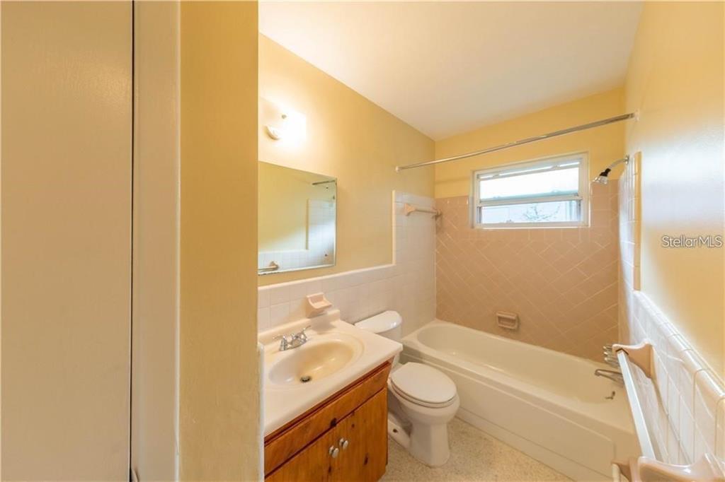 10165 106th Terrace, Unit 1 Largo, FL 33773 - Photo 7 of 9 a bathroom with a sink a toilet and shower