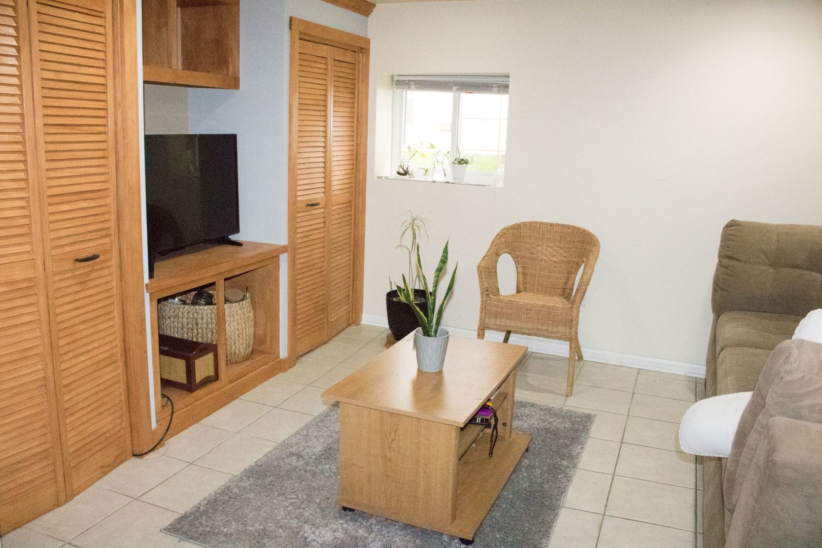 6310 West Warwick Avenue, Unit G Chicago, IL 60634 - Photo 3 of 10 a living room with furniture and a flat screen tv