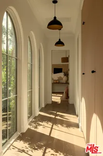 a bedroom with a bed a couch and a painting on the wall