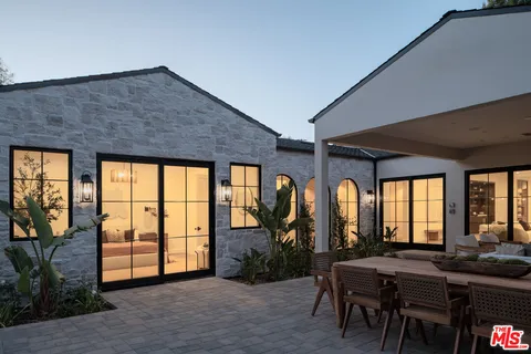 a swimming pool view with a seating space