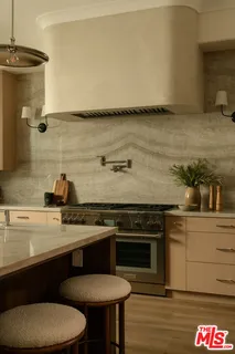 a kitchen with a sink cabinets and wooden floor