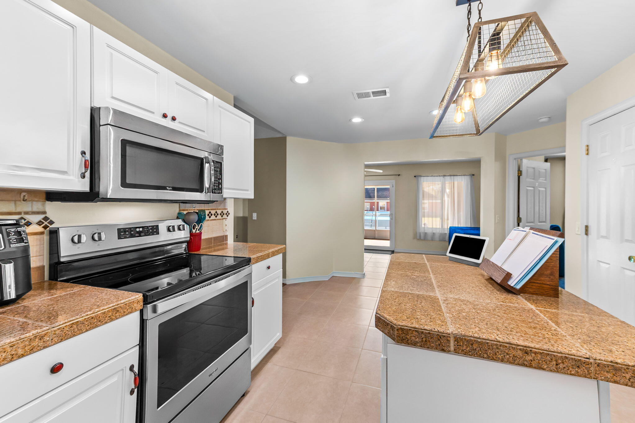 7373 Rexford Street Navarre, FL 32566 - Photo 13 of 56 a kitchen with a stove and a microwave