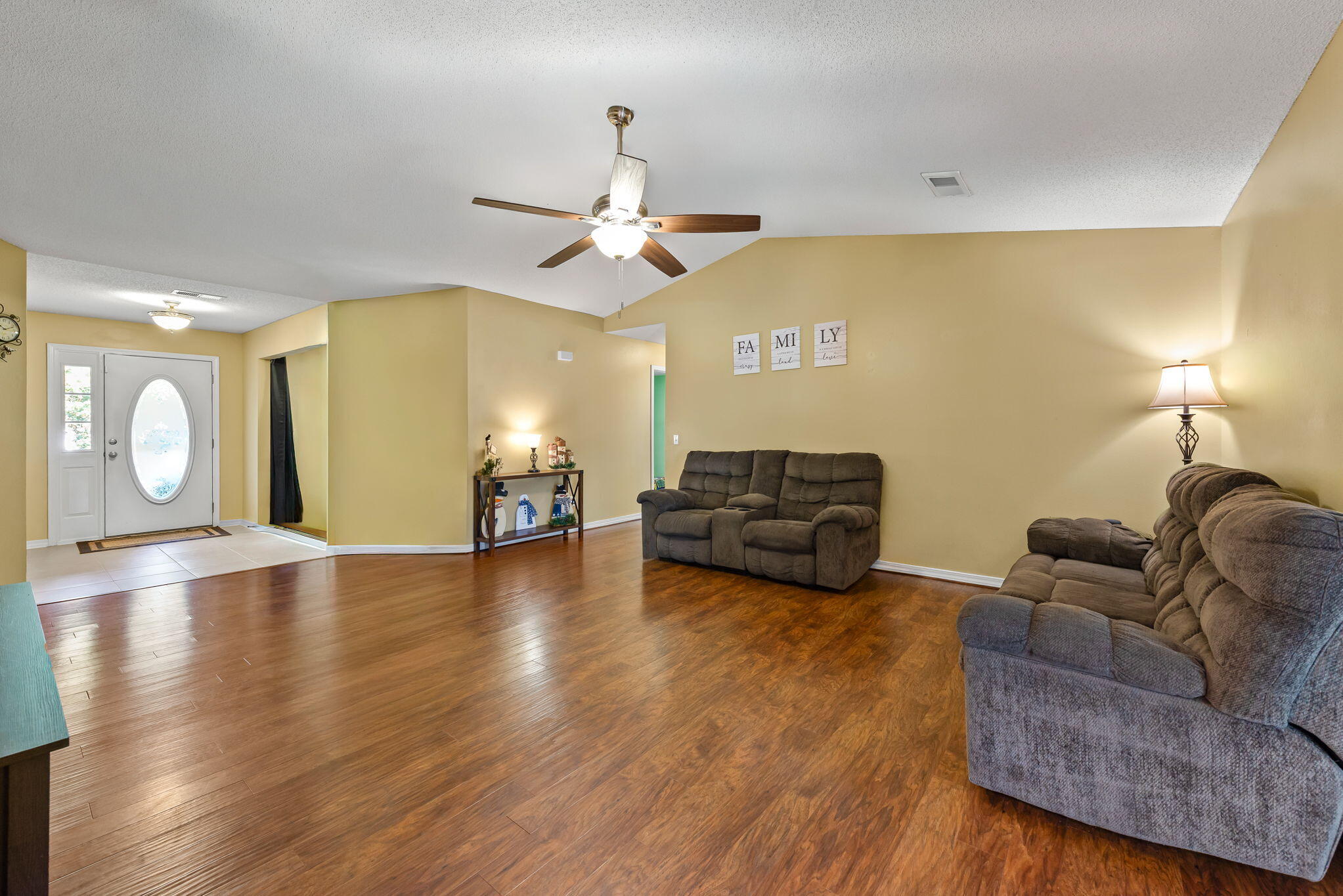 7373 Rexford Street Navarre, FL 32566 - Photo 18 of 56 a living room with furniture and a fireplace