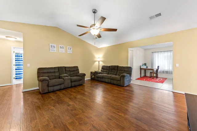 a living room with a bed and a window