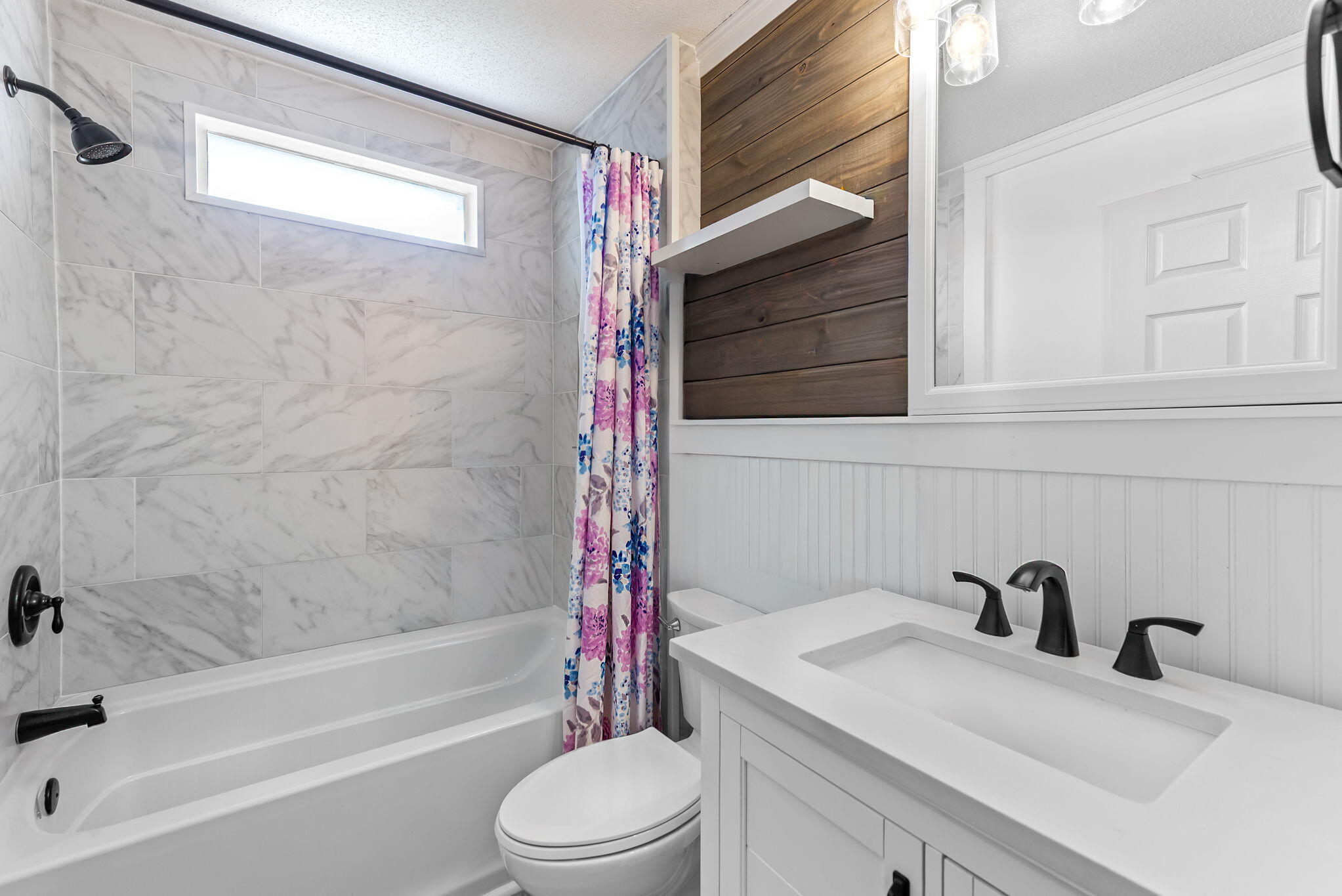 7373 Rexford Street Navarre, FL 32566 - Photo 35 of 56 a bathroom with a sink a toilet and a bathtub