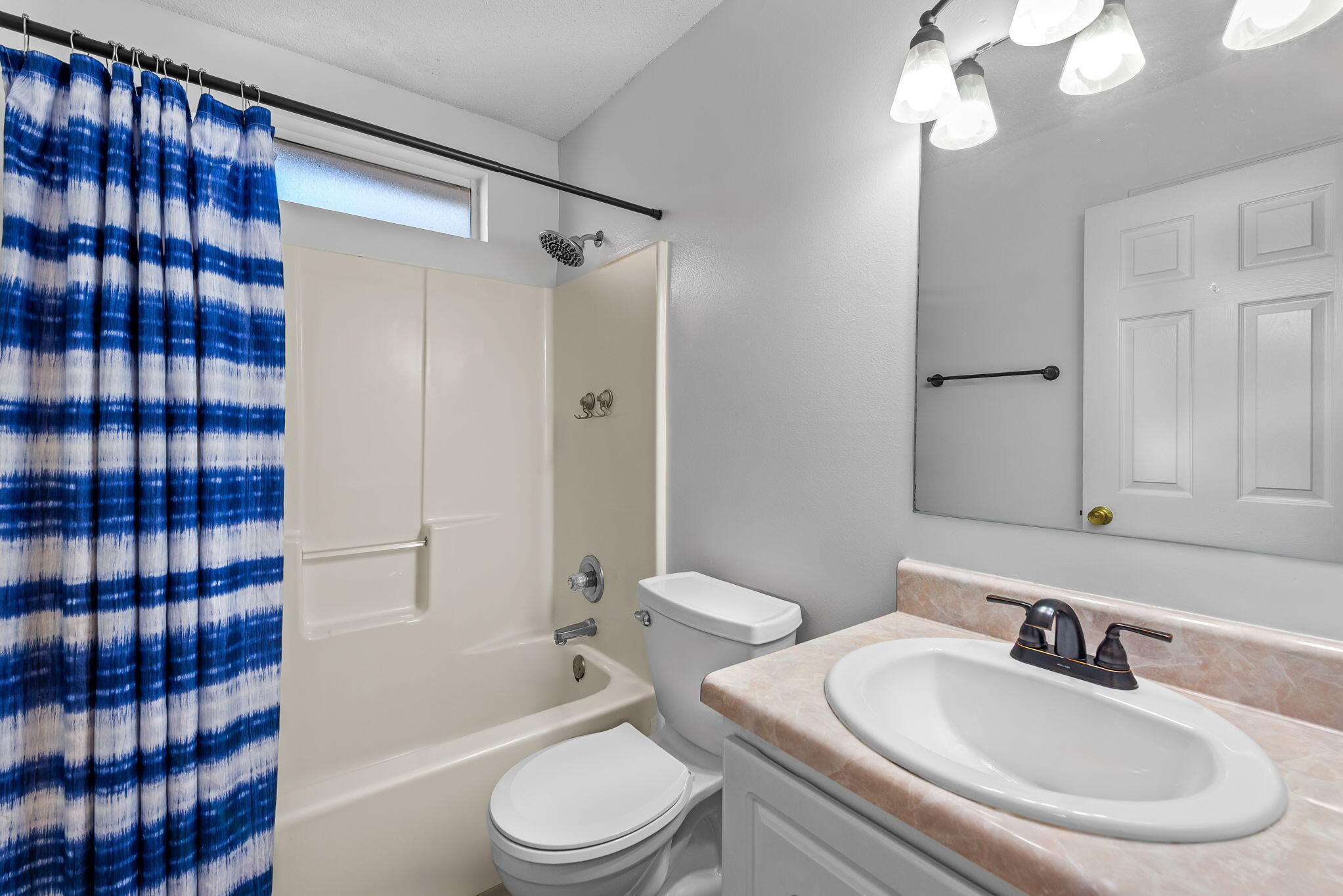 7373 Rexford Street Navarre, FL 32566 - Photo 36 of 56 a bathroom with a sink a toilet and shower