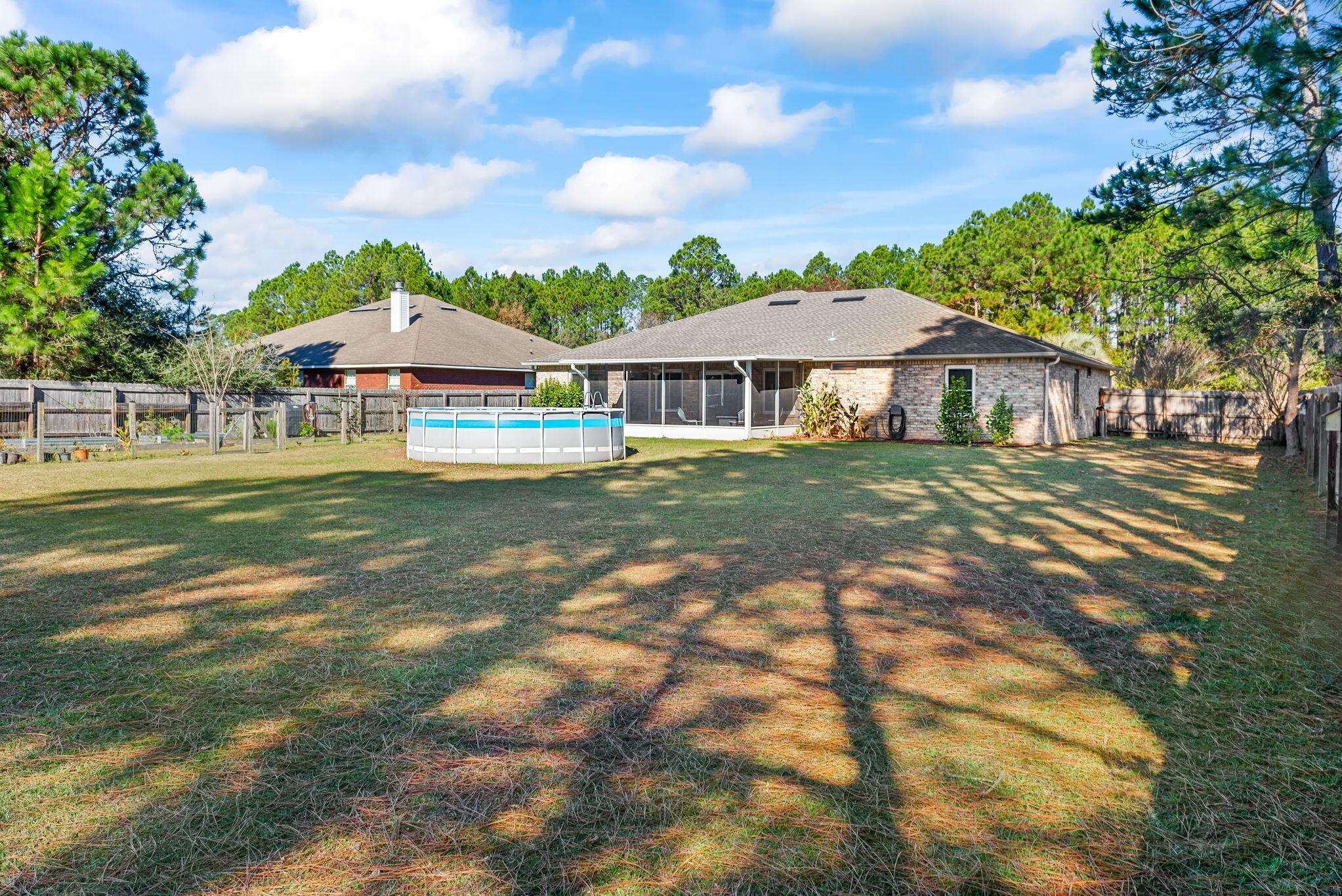 7373 Rexford Street Navarre, FL 32566 - Photo 55 of 56 a front view of a house with a garden