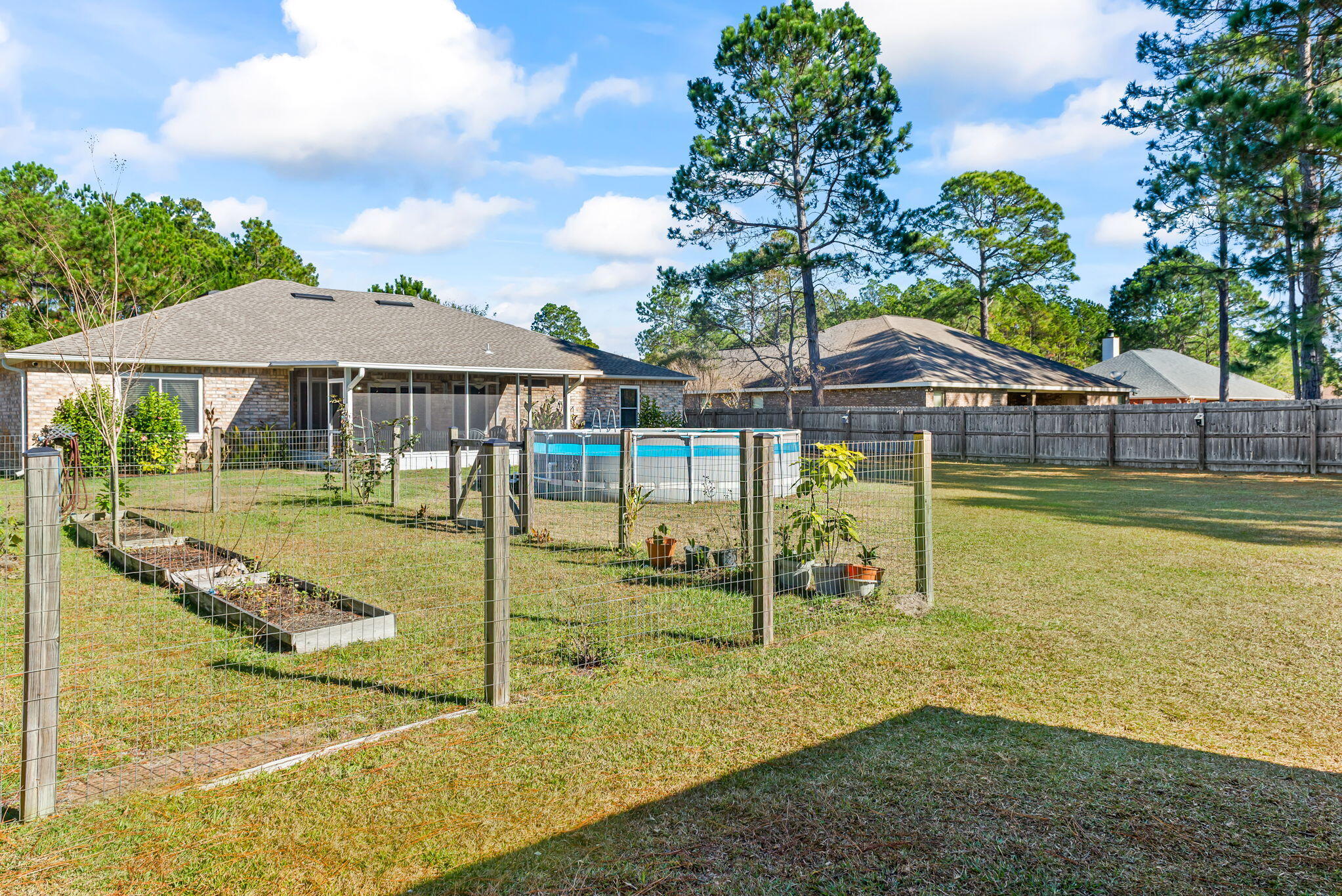 7373 Rexford Street Navarre, FL 32566 - Photo 10 of 56 a view of a swimming pool with a patio