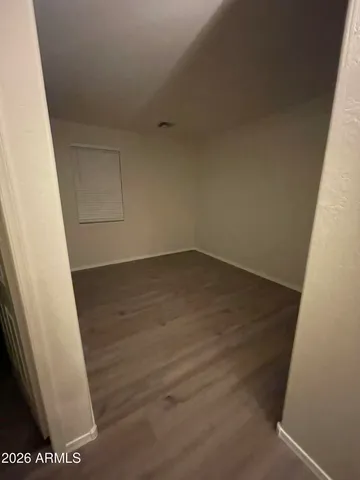 an empty room with wooden floor