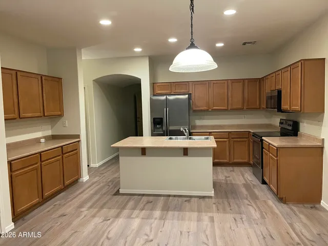 a kitchen with a sink stainless steel appliances and cabinets