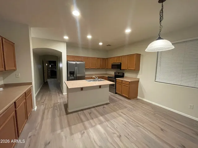 a kitchen with a sink stainless steel appliances and counter space