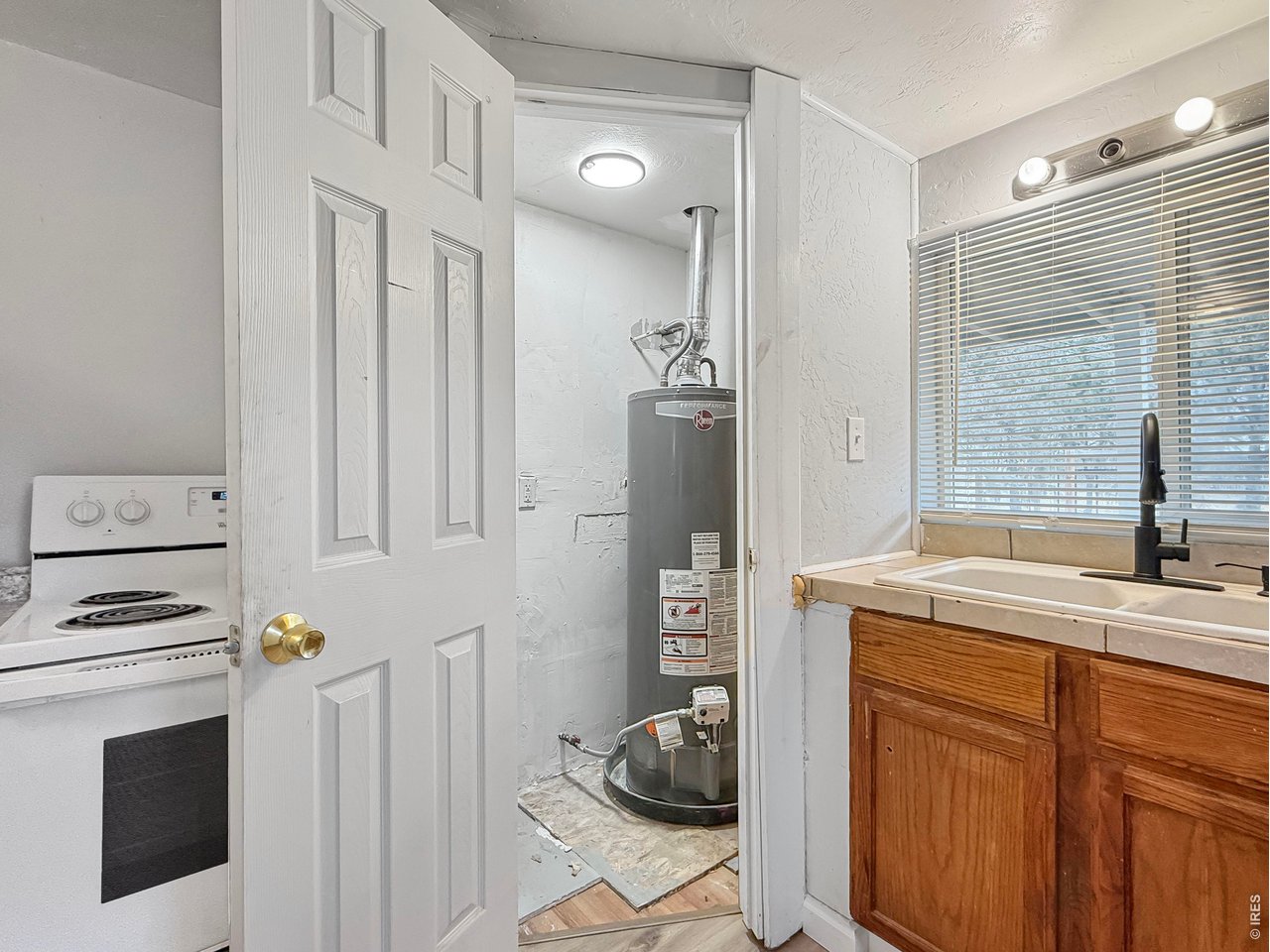720 Phelps Street Sterling, CO 80751 - Photo 12 of 27 a kitchen with a sink cabinets and appliances
