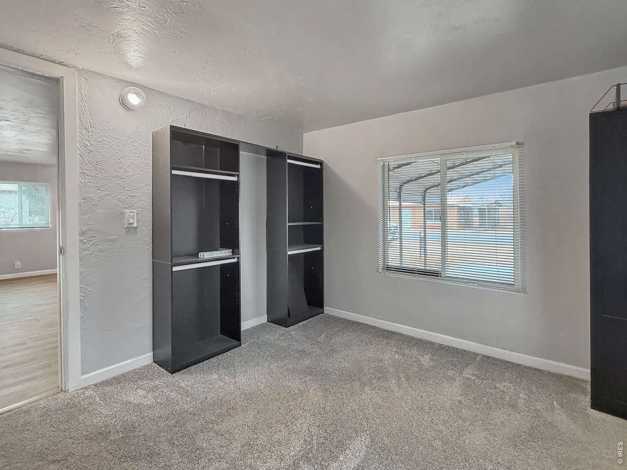 720 Phelps Street Sterling, CO 80751 - Photo 13 of 27 a view of an empty room with a kitchen